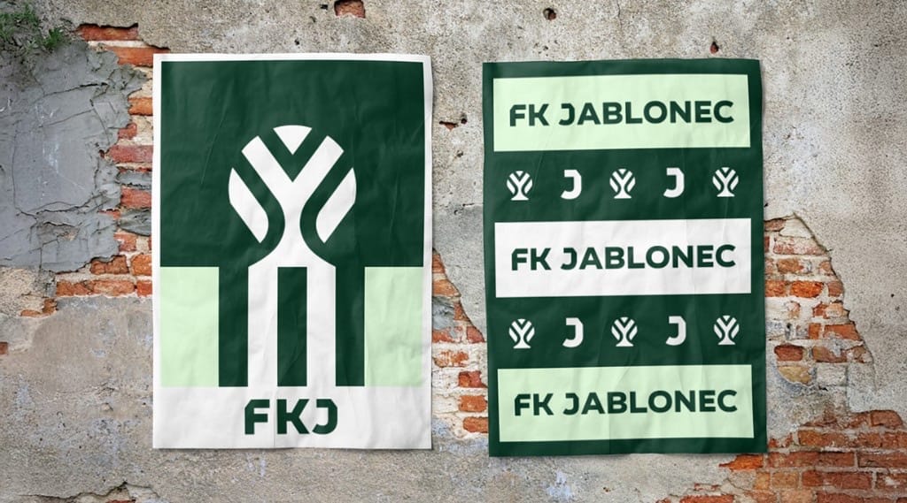 Two posters on a weathered brick wall: a large green apple-tree symbol with FKJ, and stacked FK JABLONEC bands.