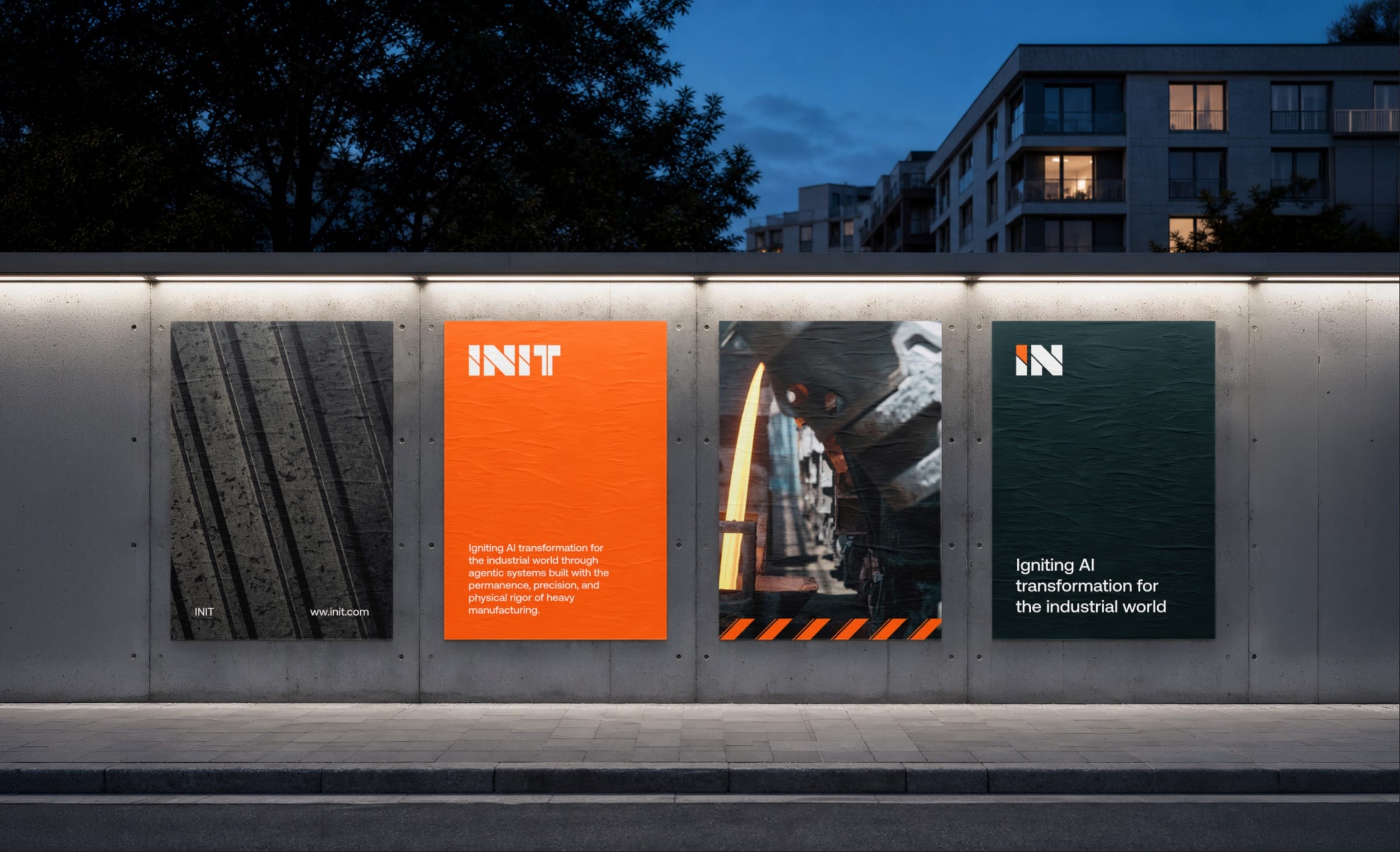 Four INIT posters on a lit concrete wall at dusk: forged metal, the logotype on orange, molten steel and the IN symbol.