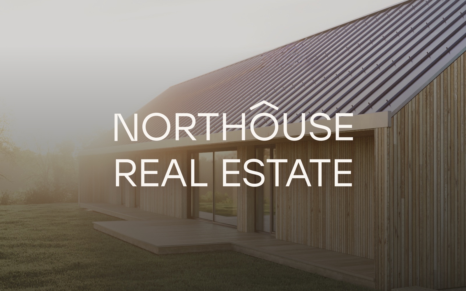 The Northouse Real Estate wordmark over a timber house with a dark metal roof in morning mist.